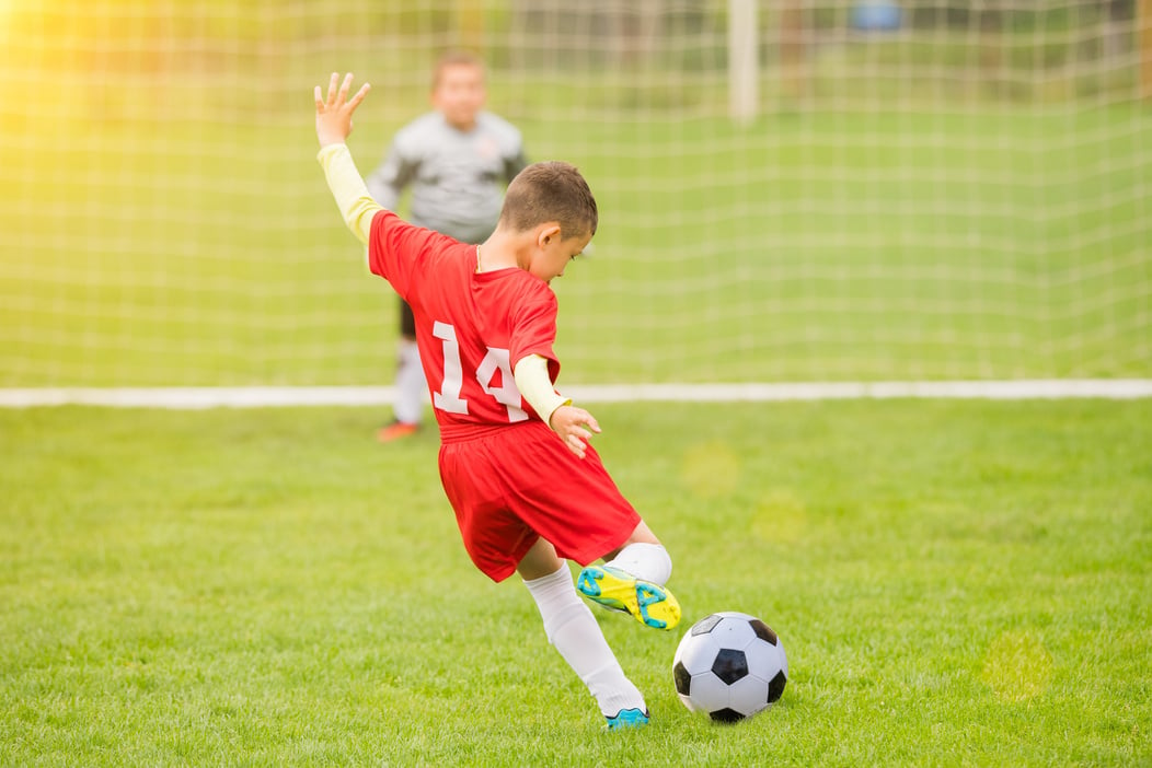 Kids soccer football - young children players match on soccer field